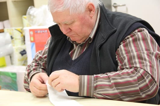 Engineering manager József Haraszti checks the quality of the converted tissue from the new line